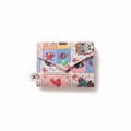 Colorful patchwork cartoon card case with green snap button, front view on white background