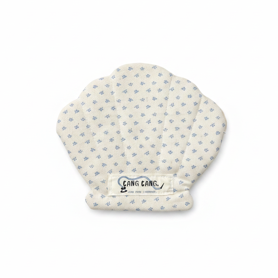 Kang Kang Shellie Pouch in cream fabric with small blue ditsy floral print and diamond quilting stitches, shell scallop shape, on white background