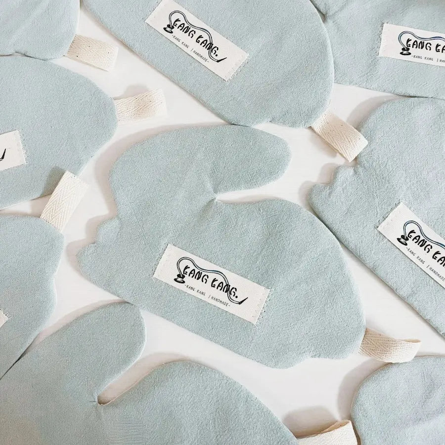 Multiple muted blue-green rabbit-shaped coasters