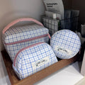 Kang Kang Handmade blue white plaid makeup bag set of 3 – large box bag, trapezoid pouch, and round coin purse displayed on wooden tray