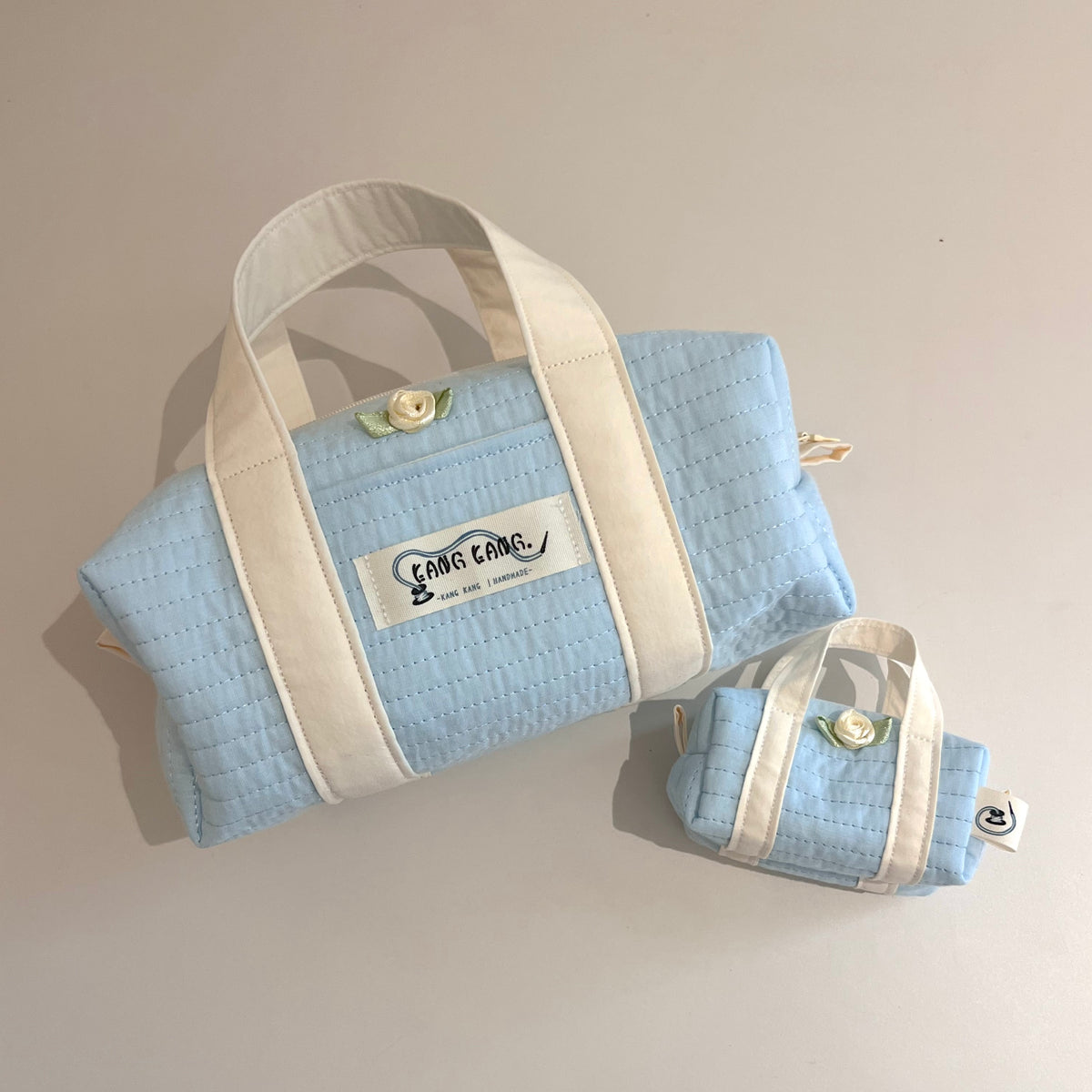 Kang Kang Handmade Together Bag in Powder Blue — solid light blue quilted fabric with cream handles and flower button detail, set of large and small bag