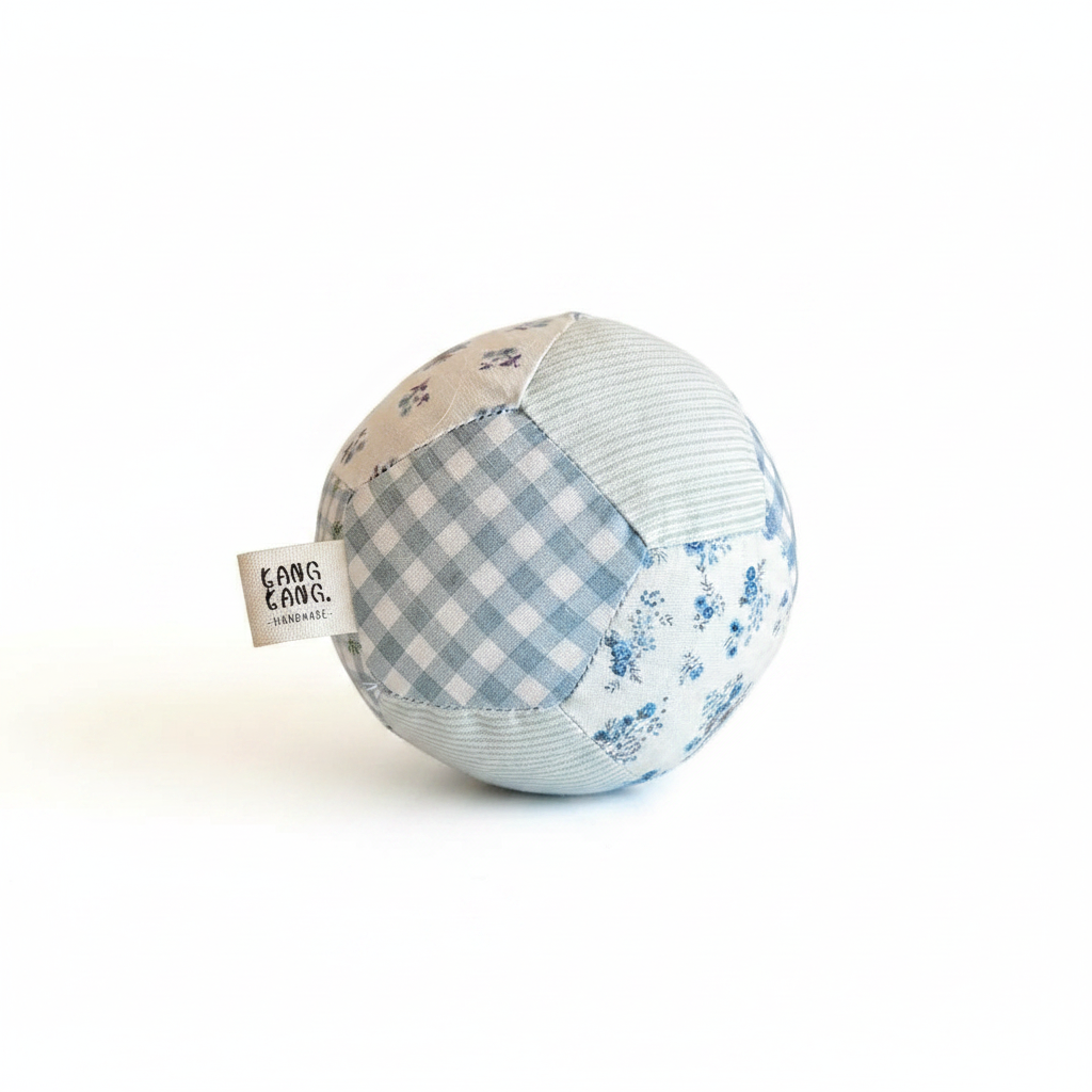 Kang Kang Handmade Patchwork Dog Ball on white background — blue gingham, floral and stripe fabric panels